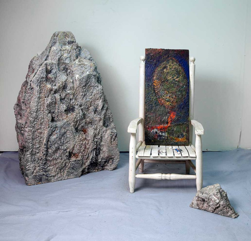 MOUNTAIN ROCK with MORGUE 2 carved Styrofoam painted rocks;old childs’ chair; plaster bits; encaustic painting on board Size variable approx. 35” x 39” x 49”